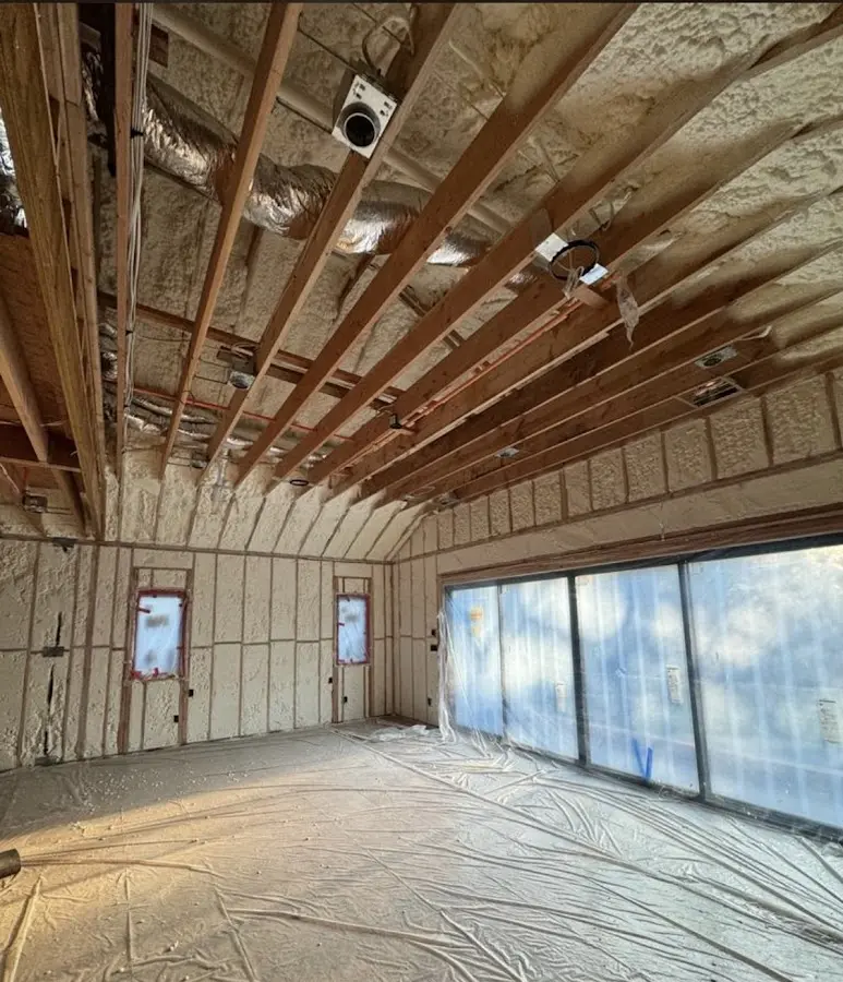 Interior walls and ceiling insulated with spray foam during new construction in Grafton